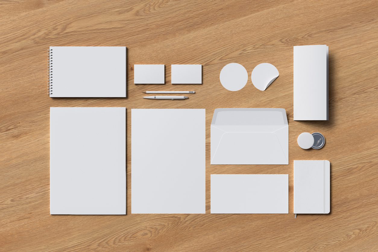 Corporate stationery is a blank slate for your brand! Image: Blank pieces of corporate stationery including notebooks, envelopes and stickers.